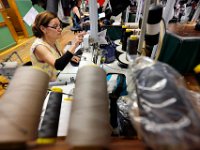 Maria Vilamariam, who has been a stitcher for over 50 years, stitches a suit jacket at the Joseph Abboud manufacturing plant in New Bedford, MA.   [ PETER PEREIRA/THE STANDARD-TIMES/SCMG